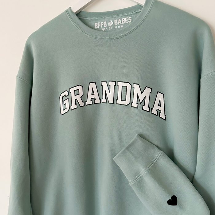 Sweatshirt hangs on hanger; reads 