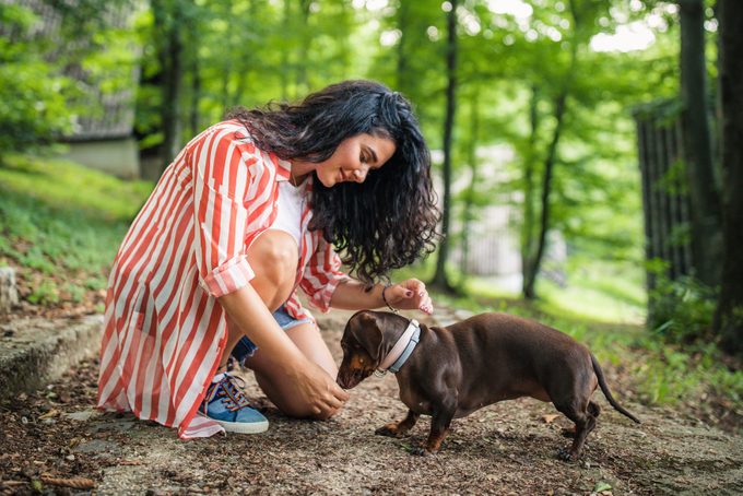 Young woman and her dog in nature