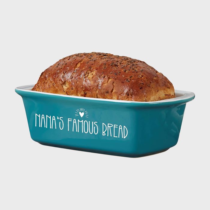 Loaf of bread rests in a blue ceramic pan labeled 