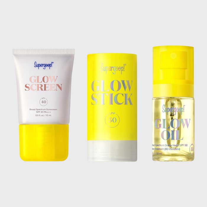 Three sunscreen products stand upright; a tube, stick, and bottle with yellow accents on a plain background. Texts: 