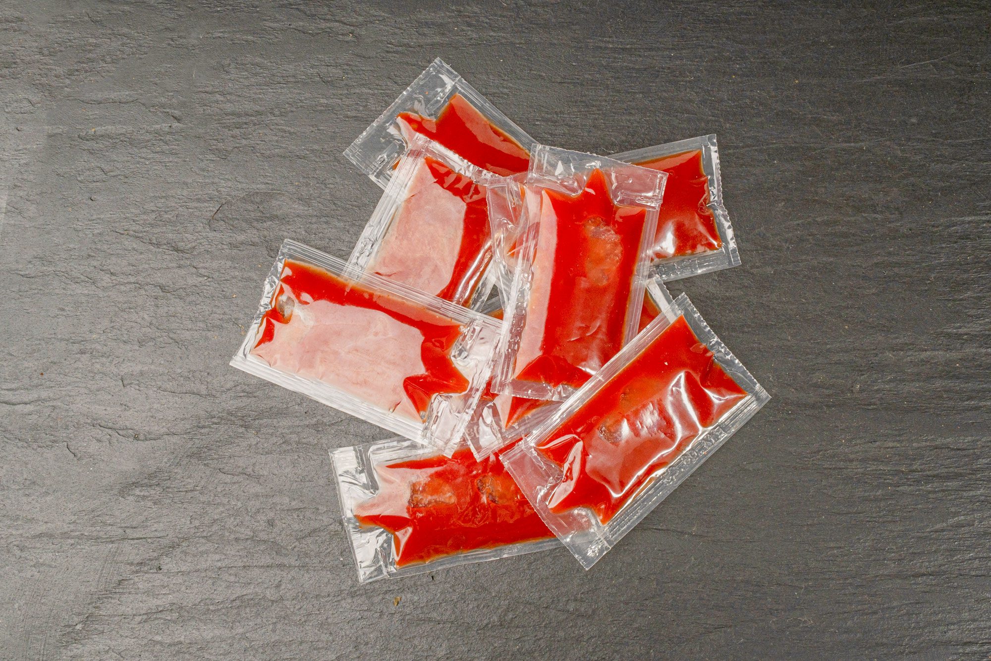 Ketchup in Square Plastic Bag on Black