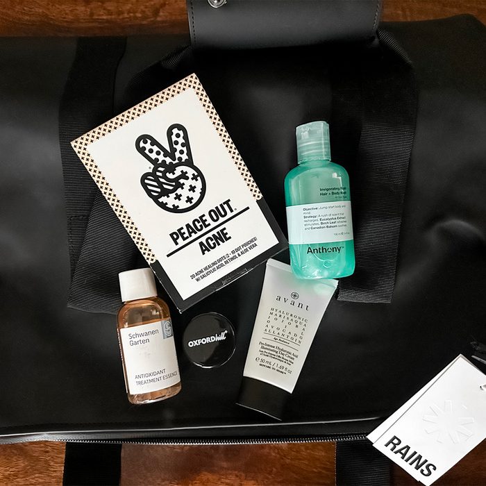 Skincare products rest atop a black bag, featuring 