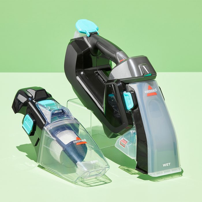 Two vacuum attachments sit on a clear surface; one labeled 