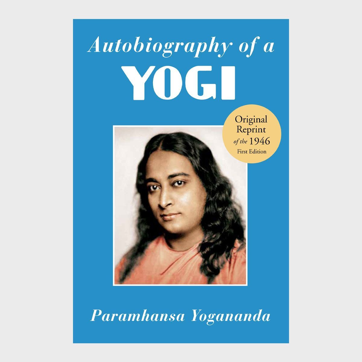 Book cover features photograph; title "Autobiography of a Yogi," author "Paramhansa Yogananda," blue background, and yellow sticker stating "Original Reprint of the 1946 First Edition."