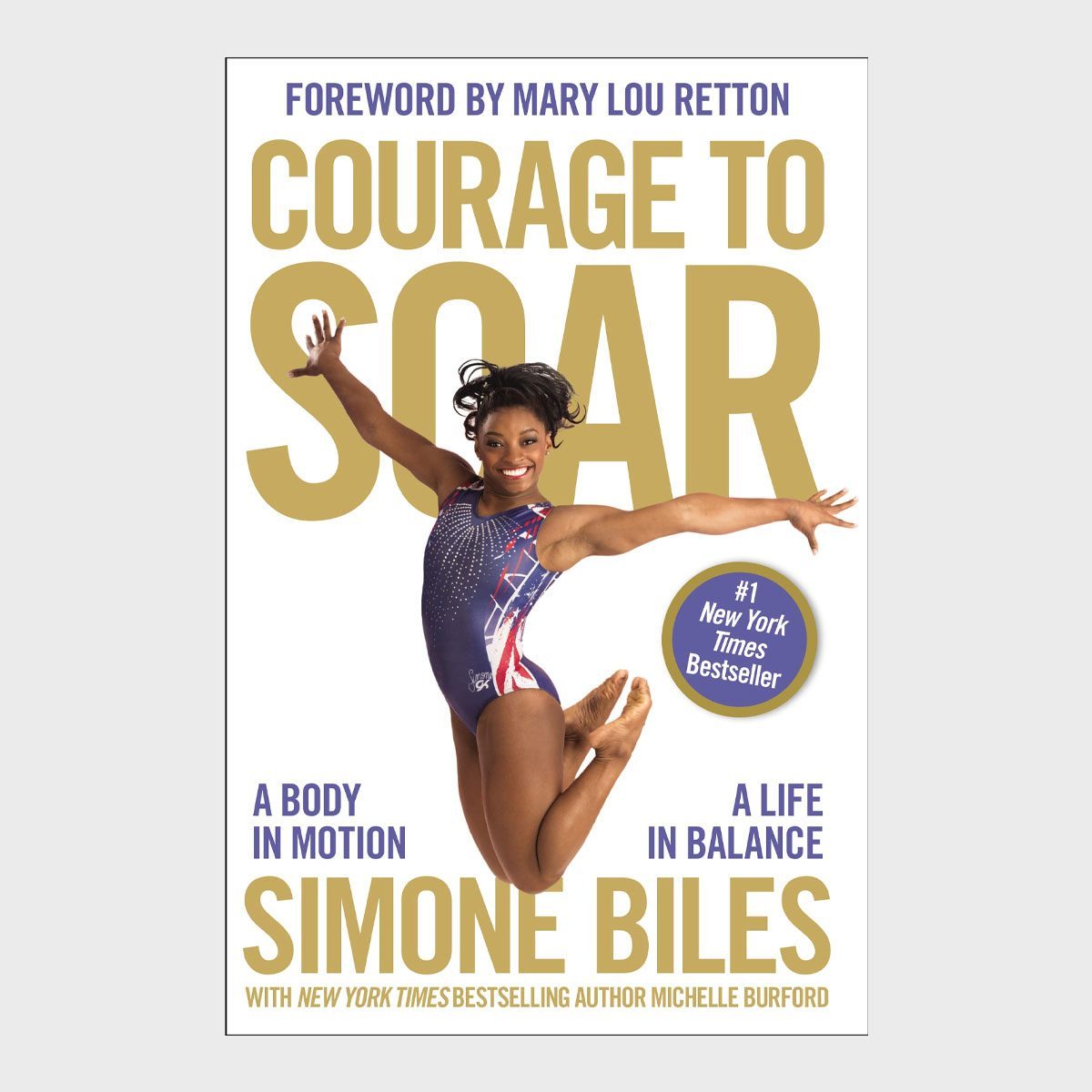 Gymnast performing leap on book cover, titled "Courage to Soar," by Simone Biles, set against a plain white background.