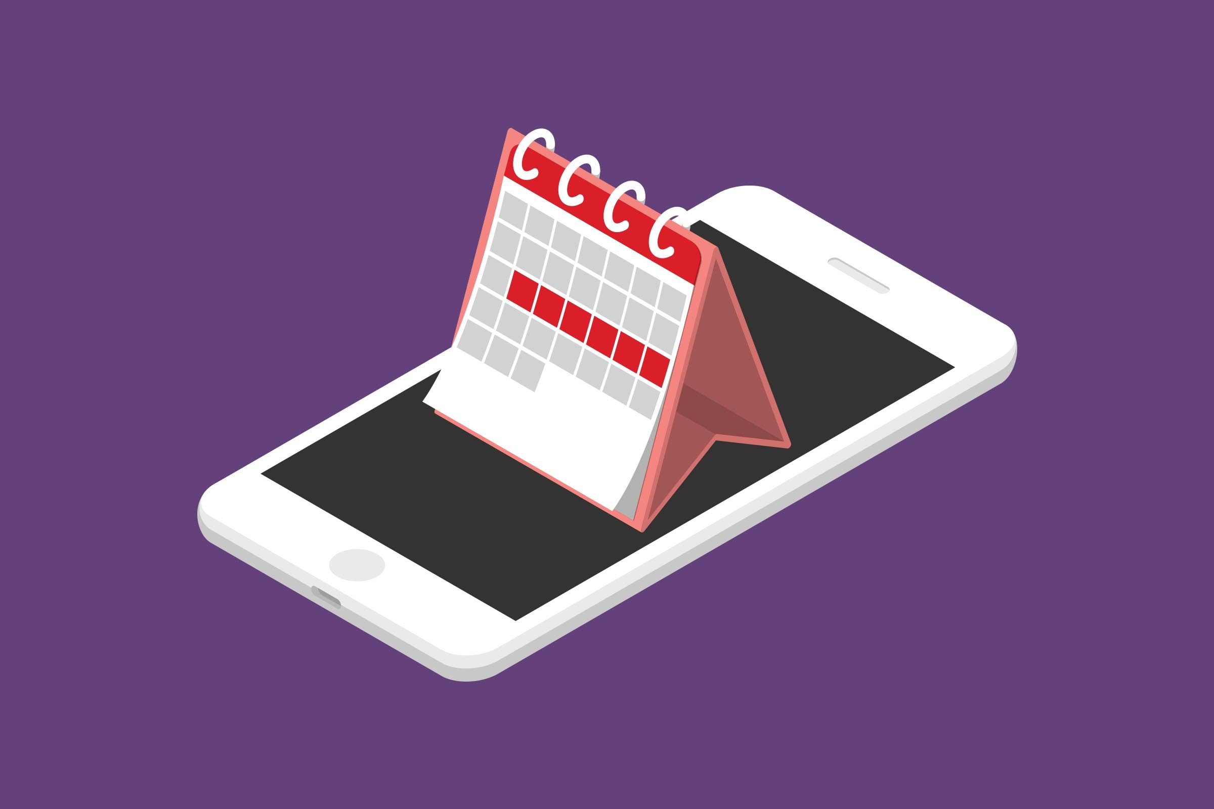 A small desk calendar stands on a smartphone, against a plain purple background.