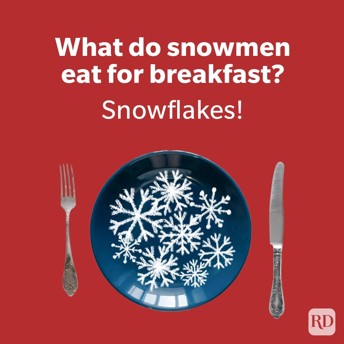 Plate holds snowflakes, placed between fork and knife against red backdrop. Text reads: "What do snowmen eat for breakfast? Snowflakes!"