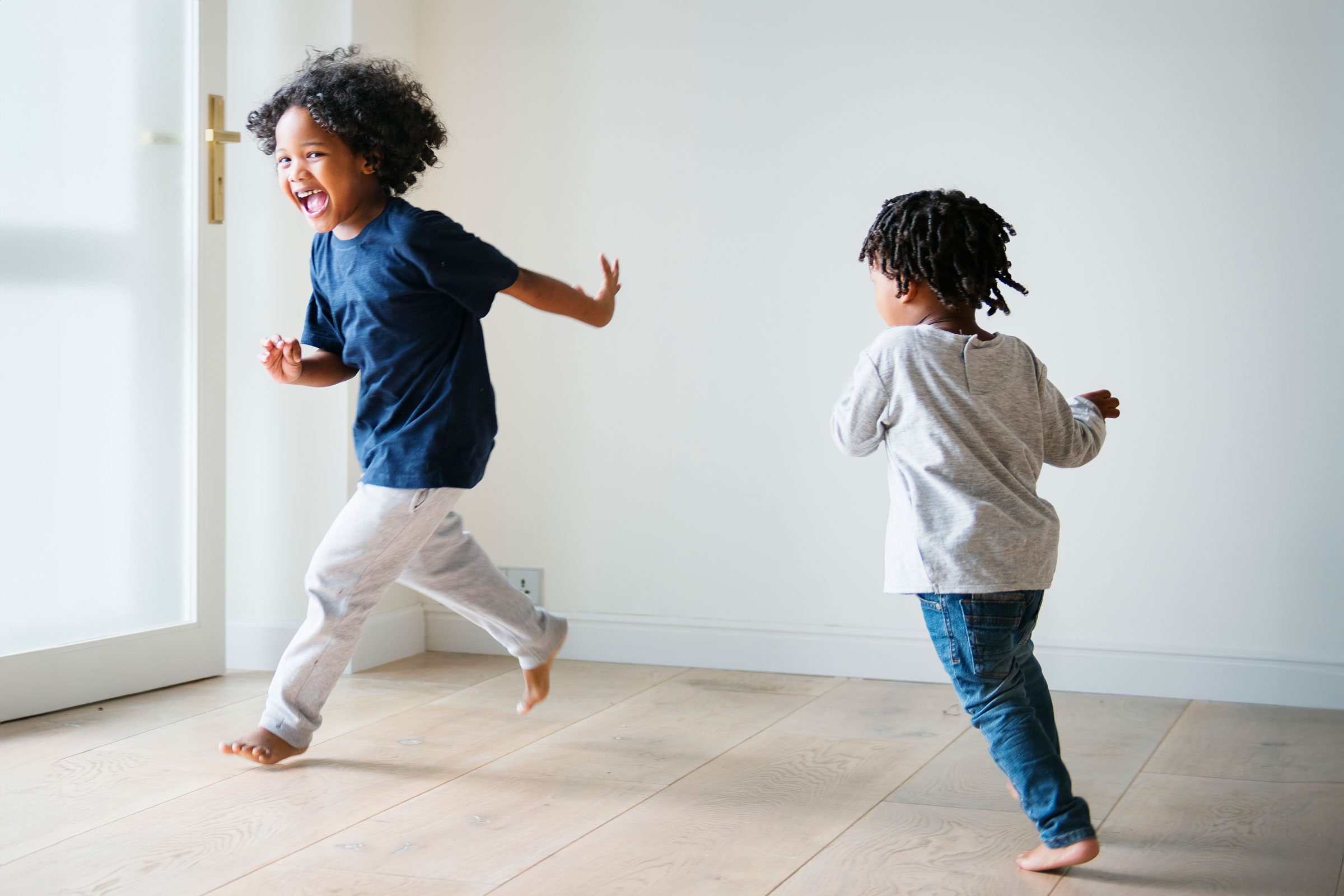 two kids running around a waiting room