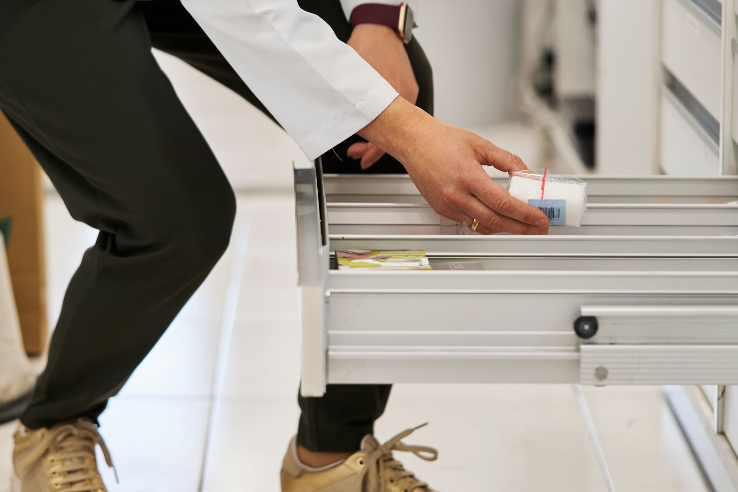 patient taking things from doctor drawers