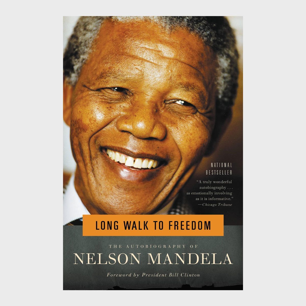 Smiling individual on a book cover titled "Long Walk to Freedom." Text: "The Autobiography of Nelson Mandela." Includes a review and forward by Bill Clinton.