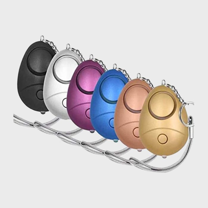 Egg-shaped keychains display in a line, featuring black, white, pink, blue, gold colors, with metallic chains, on a plain background.