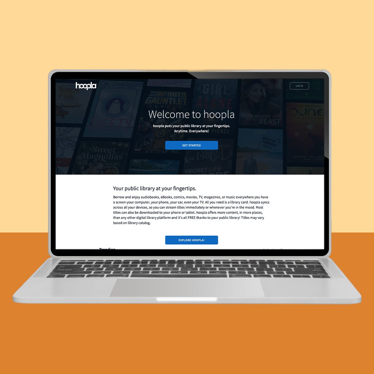 A laptop displays the Hoopla website; the screen shows a welcome message and buttons for getting started, against a warm, two-tone background.