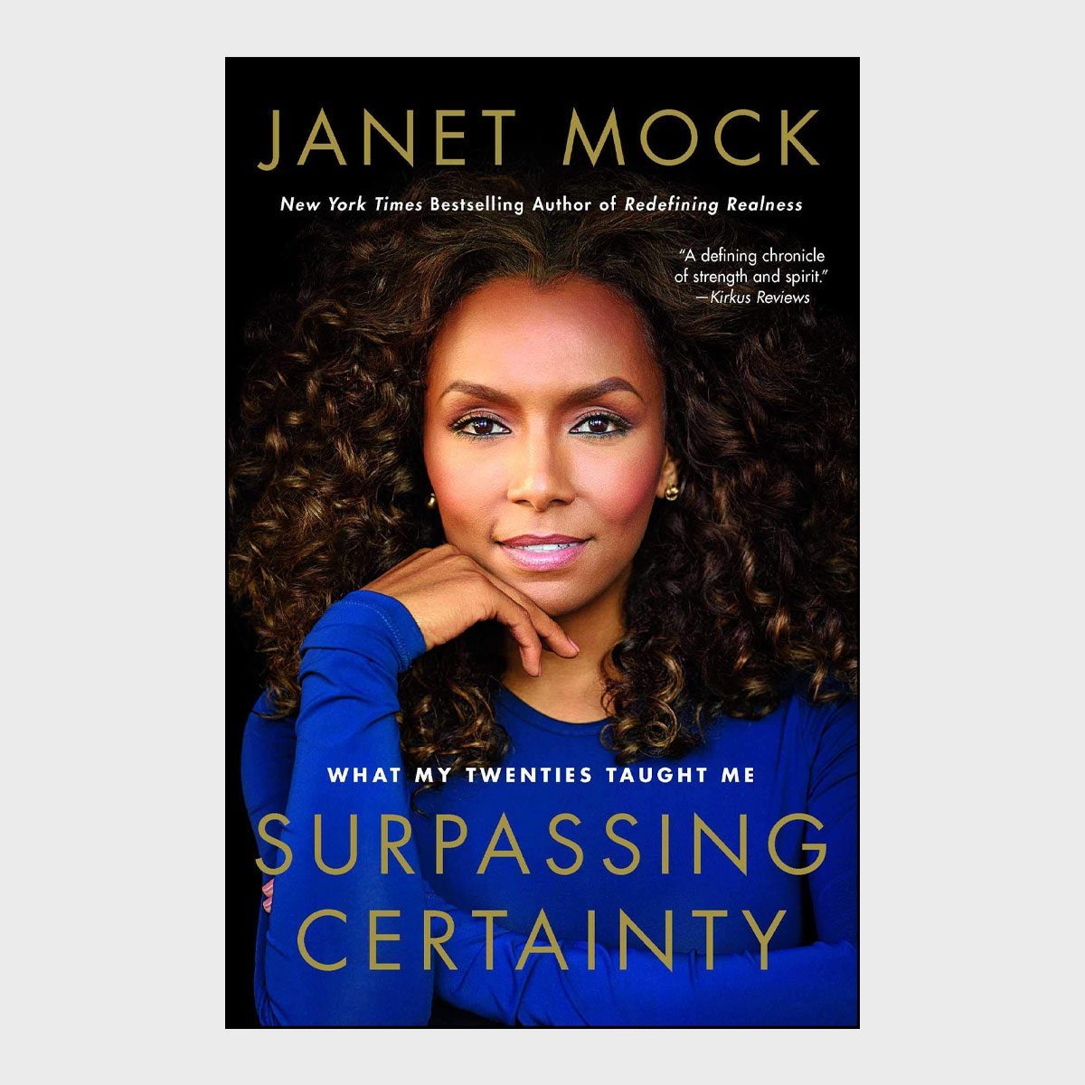 A woman poses thoughtfully with her chin resting on her hand; text reads: "Janet Mock, Surpassing Certainty, What My Twenties Taught Me."