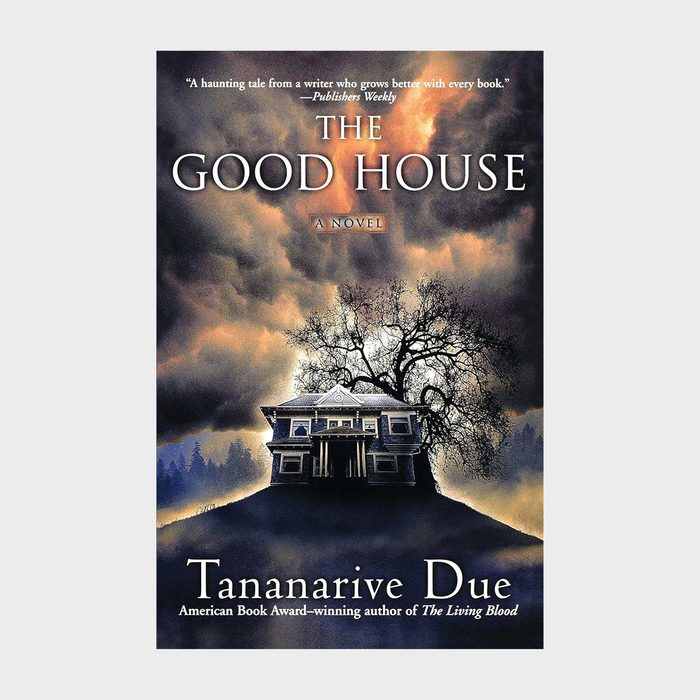 A dark house stands ominously beneath a large tree with swirling clouds overhead; text reads 
