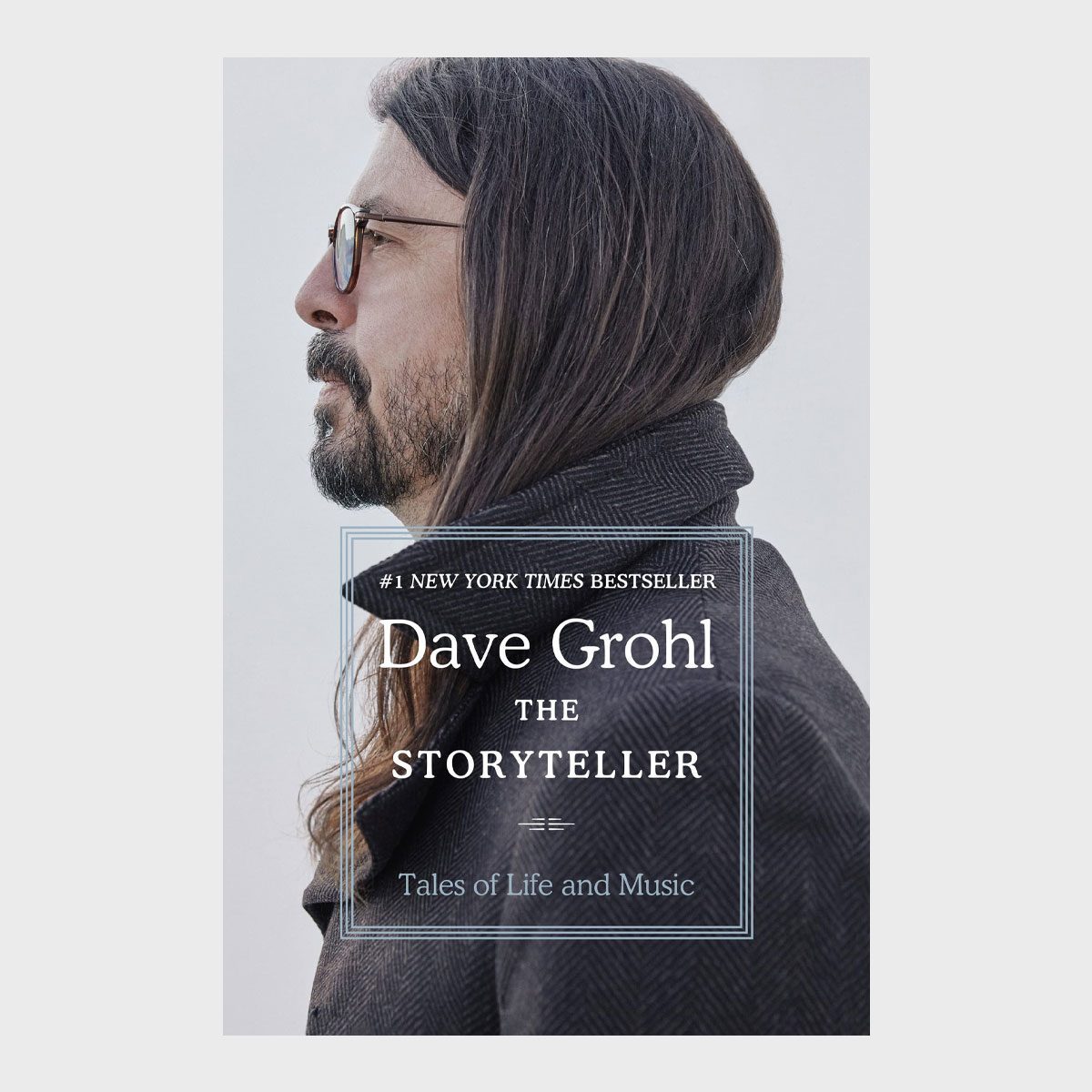 Man gazes left, wearing glasses and coat, seen in profile against a gray background. Text: "#1 NEW YORK TIMES BESTSELLER, Dave Grohl, THE STORYTELLER, Tales of Life and Music."