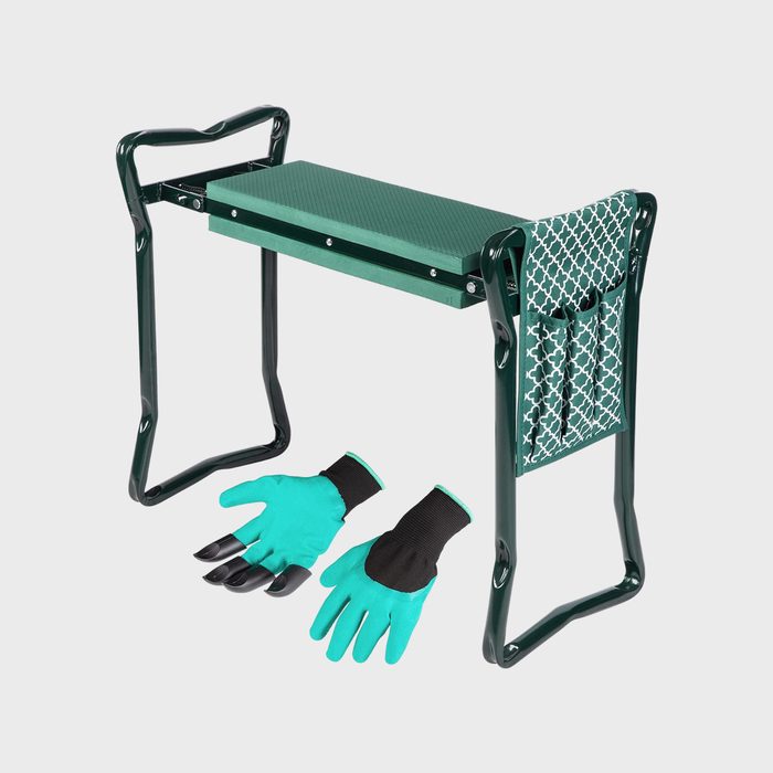 Green kneeling bench stands upright; teal gloves with black claw-tips lay below; set in a minimal, plain background.