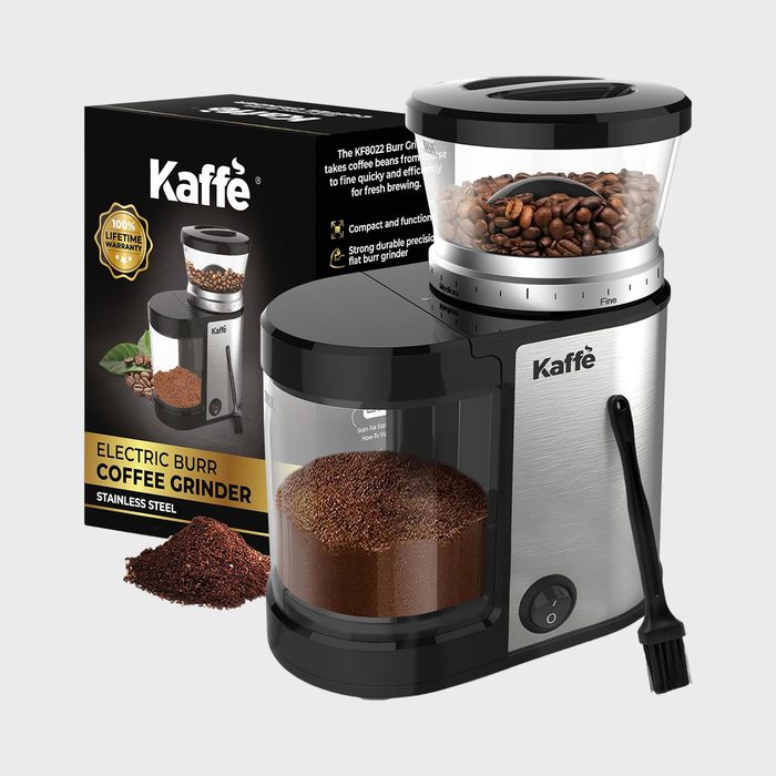 Coffee grinder processes beans into grounds; side box displays product details and warranty in a kitchen setting.