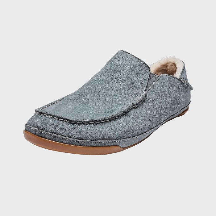 Gray loafer sits on a plain white background, featuring a soft, textured exterior and a light brown sole.