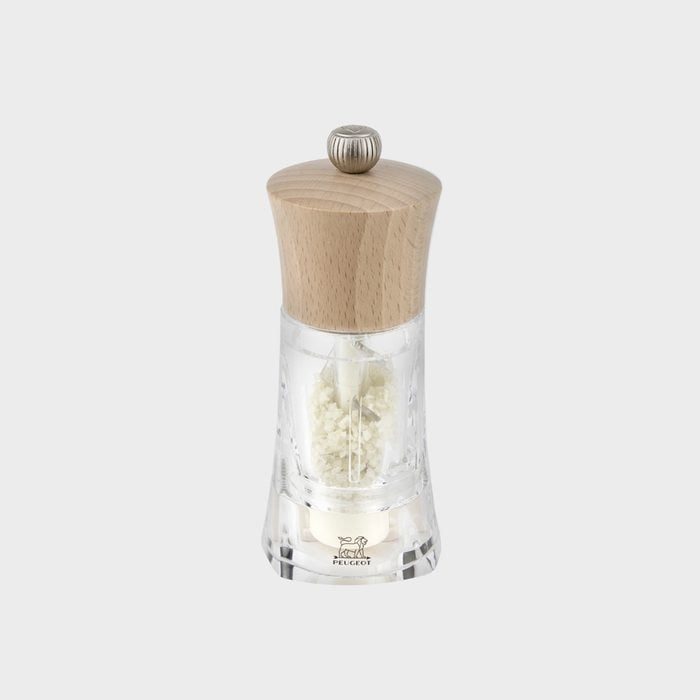 Wooden-topped salt grinder sits on white background. Transparent body reveals coarse salt inside. Branding 