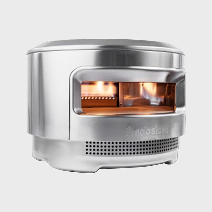 Stainless steel pizza oven with flames inside, set against a plain light gray background.