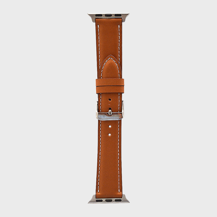 Brown leather watch strap with white stitching, featuring a silver buckle; displayed on a light gray background.