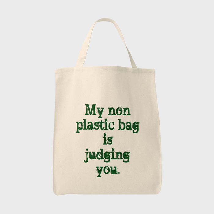 Tote bag displays green text saying, 