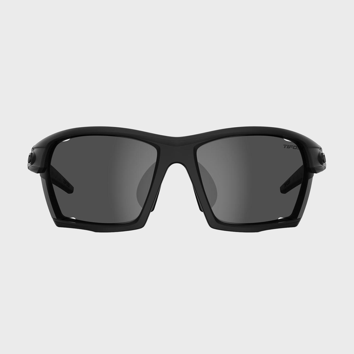 Sunglasses rest on a plain background, featuring a sleek black frame and dark-tinted lenses.