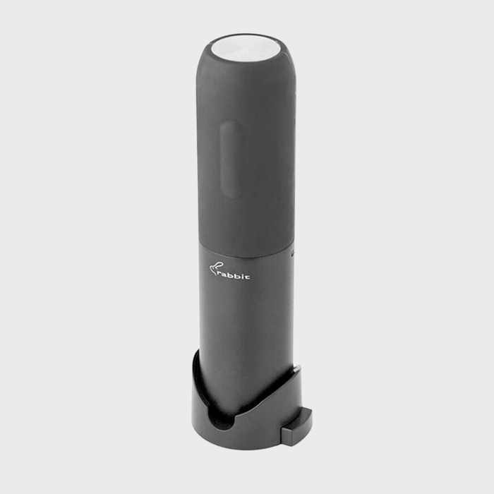 Cylindrical wine opener stands vertically on a minimalistic base; 