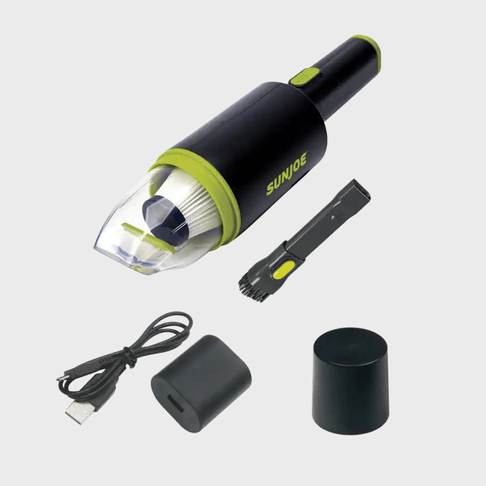 Vacuum cleaner displayed with attachments and USB cable on a white background. Vacuum has 