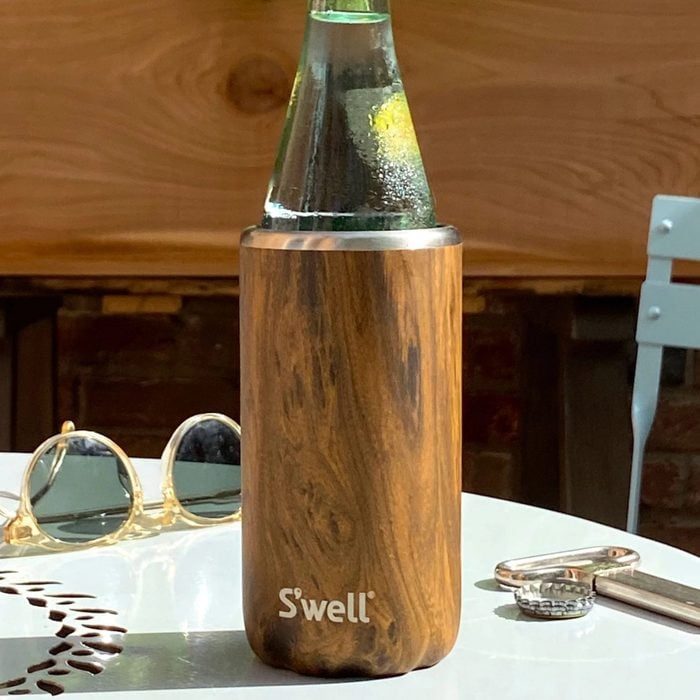 Bottle sits in a wooden sleeve, labeled 