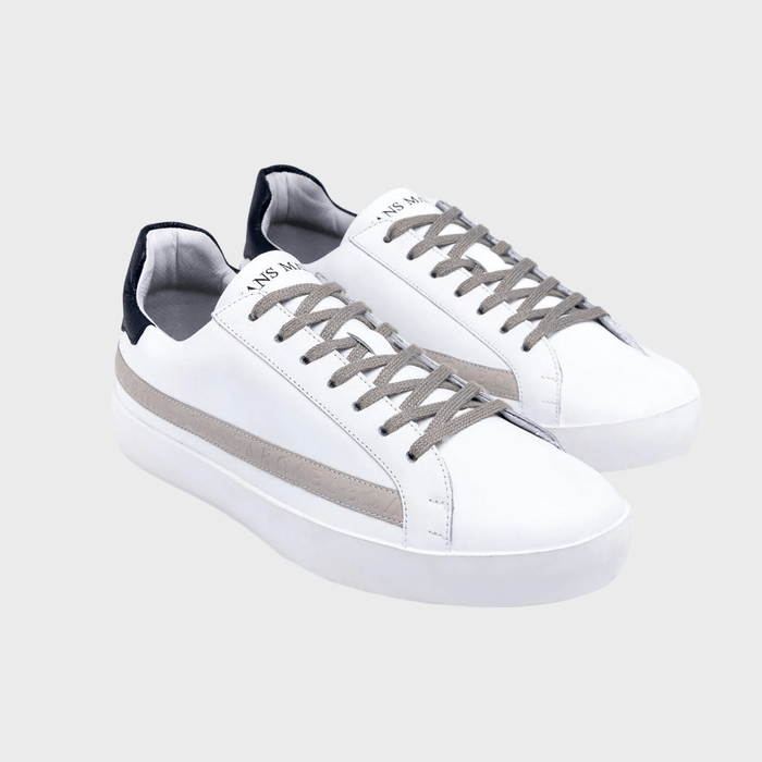 White sneakers with gray laces and stripe, set against a plain, light gray background.