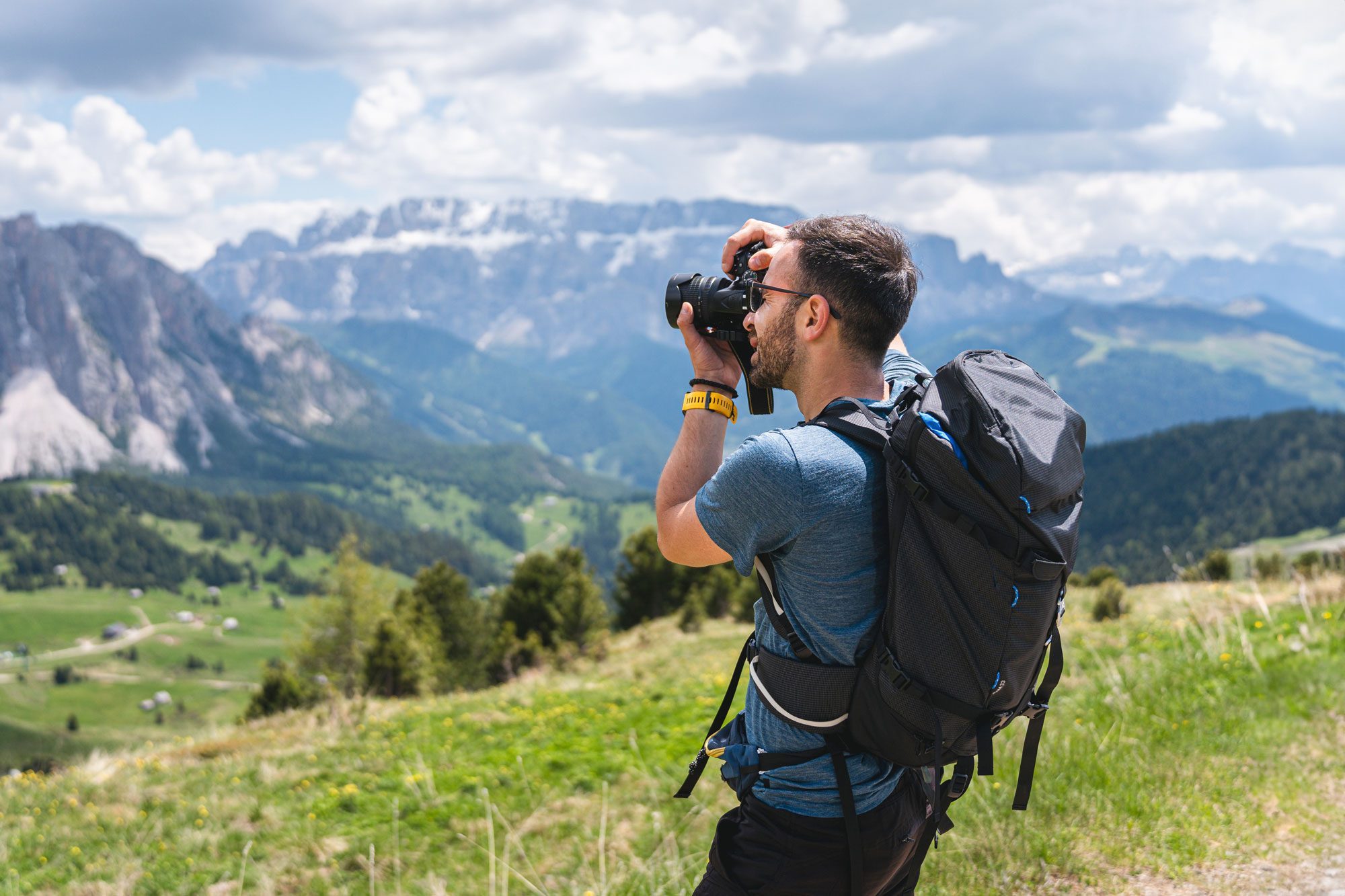 A Young Male Caucasian Hiker With A Camera Taking Photos Of The Alpe Di Seceda