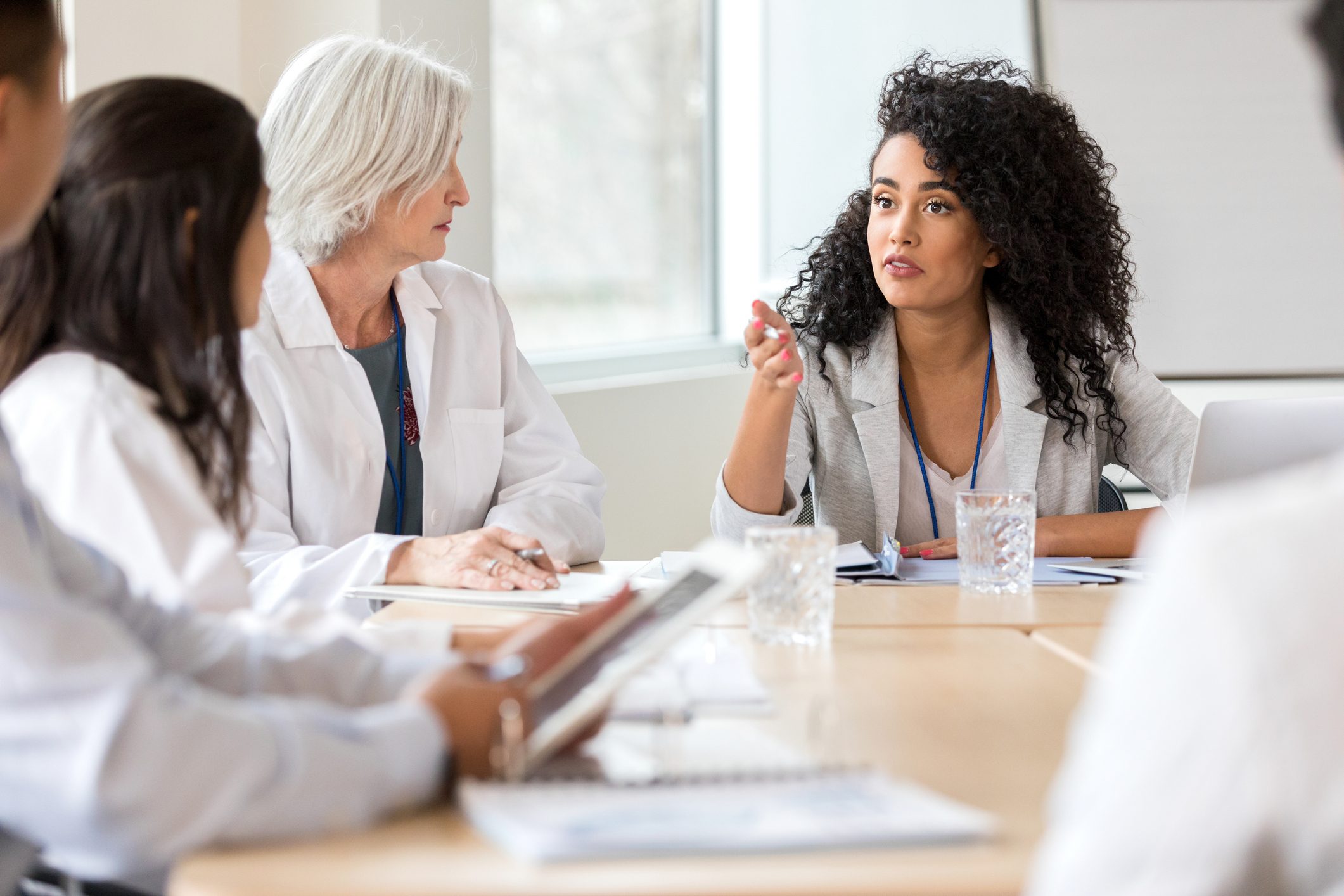 Young hospital administrator meets with medical staff