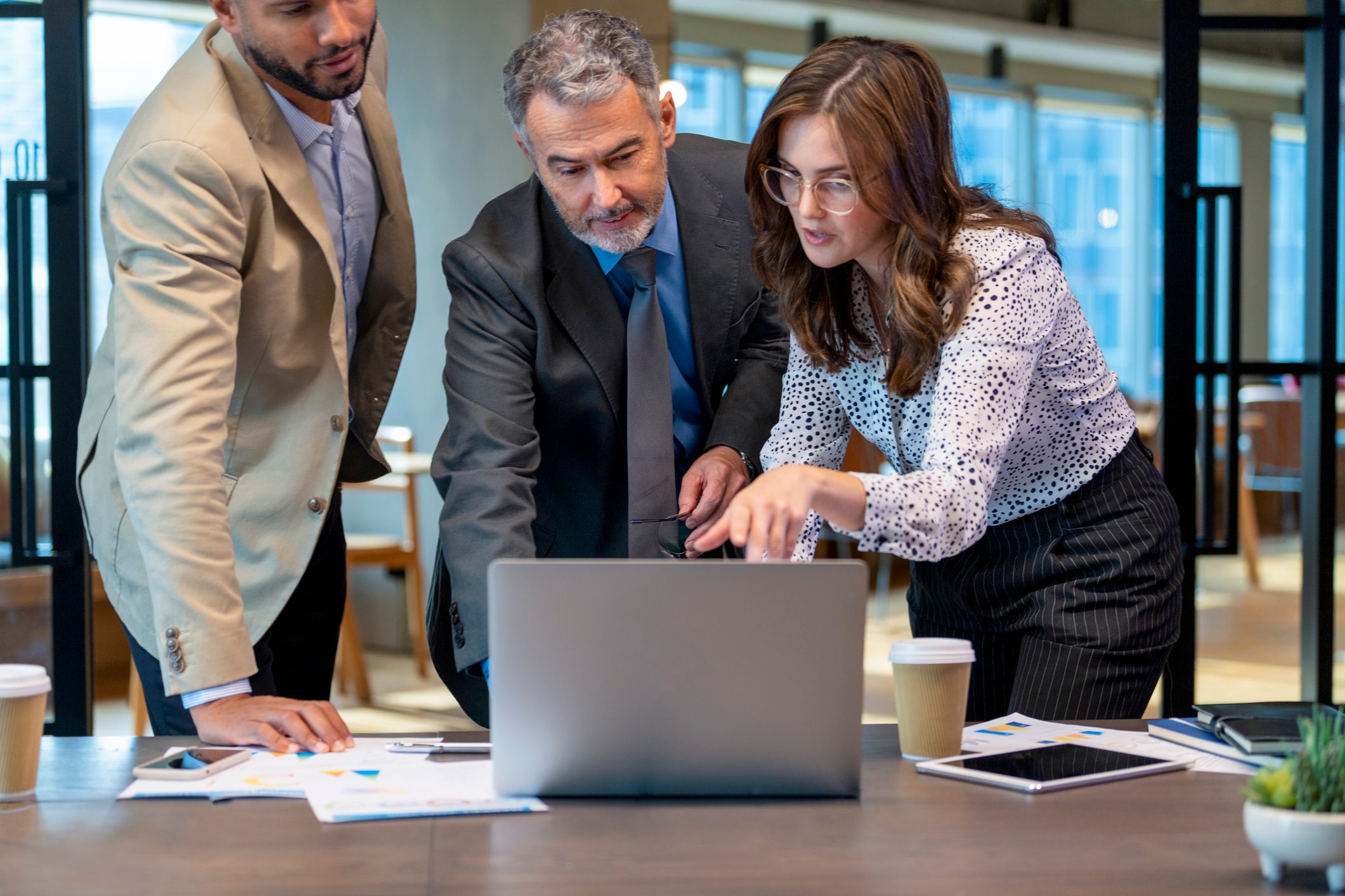 Business team working on a laptop computer.