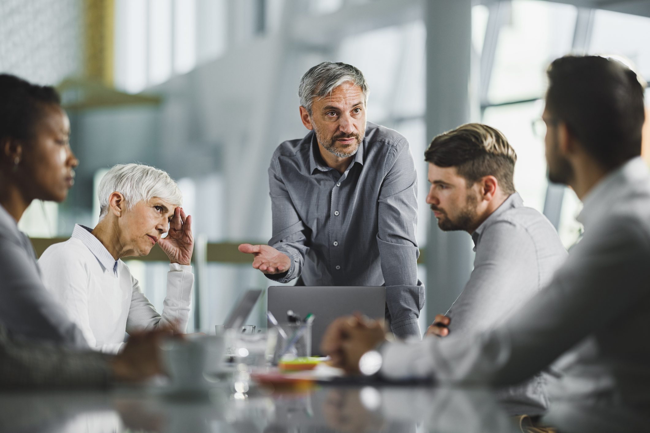 Male CEO talking to his team on a meeting in the office.