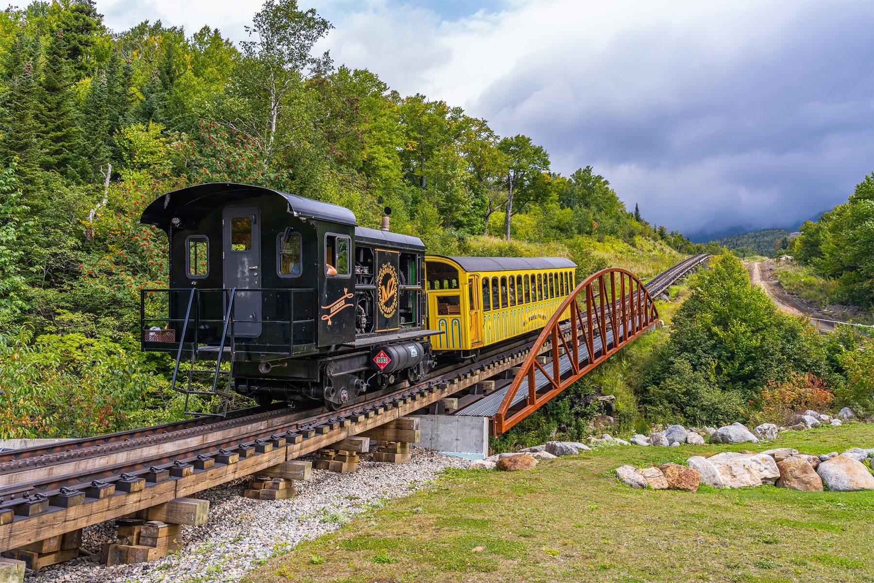 Climbing train on rack railway takes tourists to the top of Mount Washington