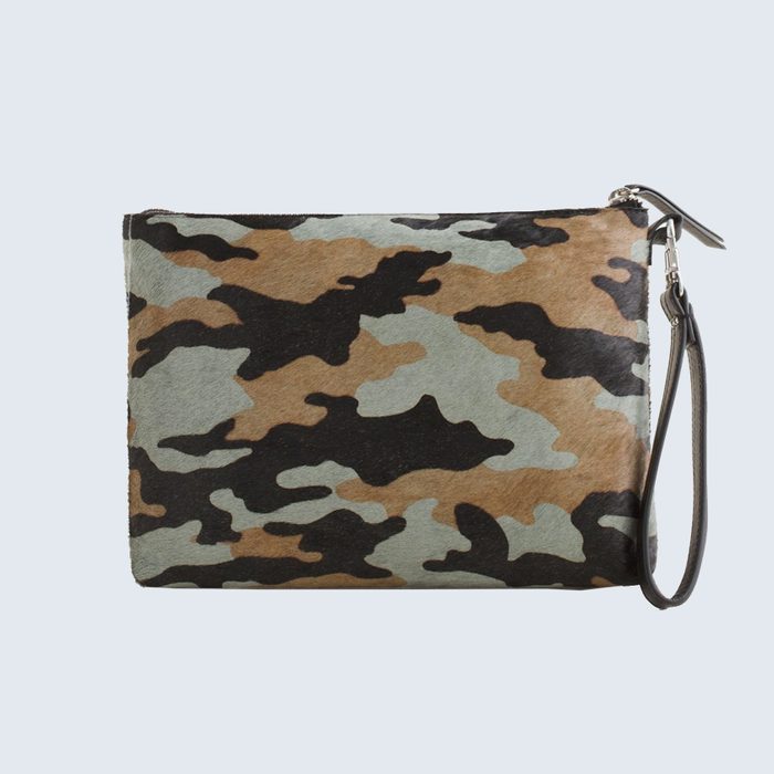 A camouflage-patterned clutch bag with a wrist strap sits against a plain light background.