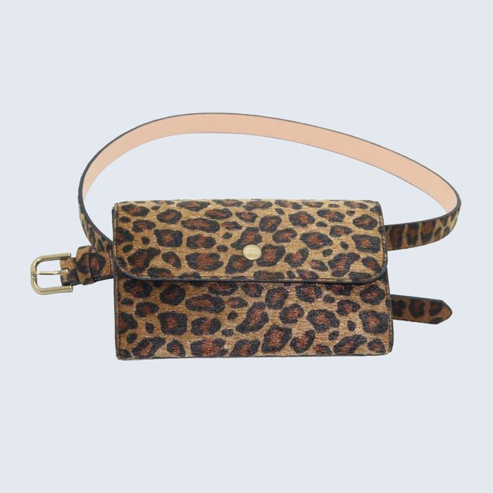 Belt bag displays a leopard print design, resting against a pale blue background.