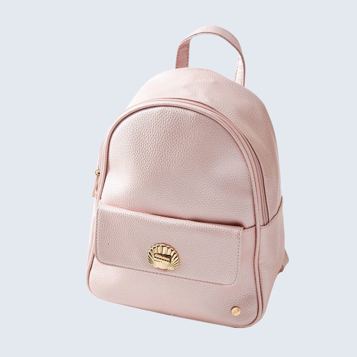 Pink backpack displayed; features a gold emblem on the front pocket, against a plain light background.