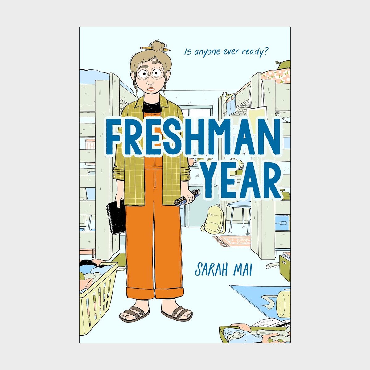 Character stands holding books and phone, looking surprised in a cluttered dorm room. Text reads: "Is anyone ever ready? FRESHMAN YEAR, SARAH MAI."