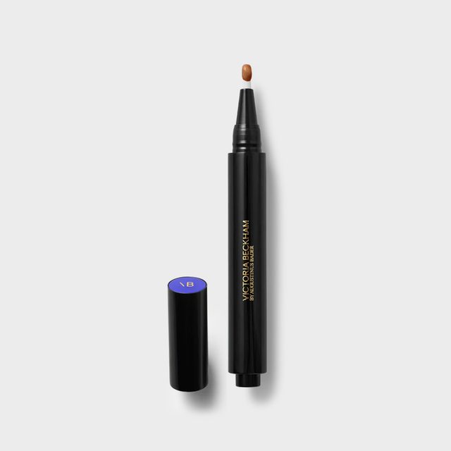 Black cosmetic pen dispenses brown liquid on a white surface; its cap lays beside it. Text reads 