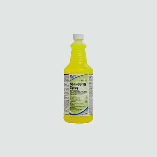 Yellow spray bottle standing upright, labeled 