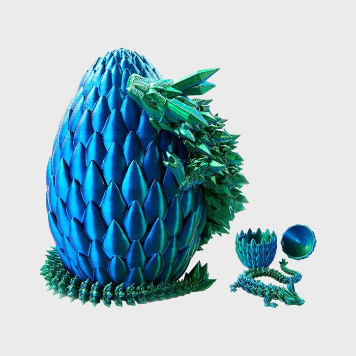 A blue, scale-patterned egg with a small green dragon emerging; disassembled segments reveal more dragon parts on a plain white background.