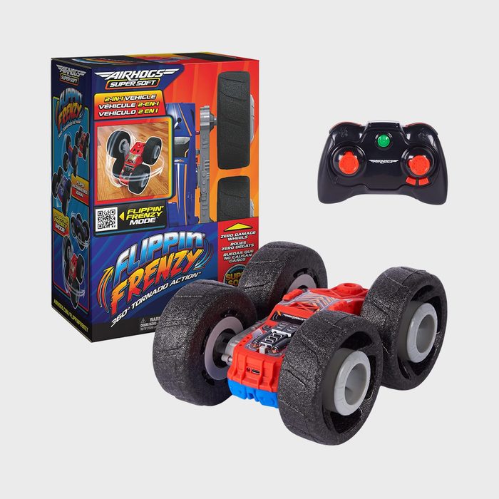 Toy car positioned beside its box, accompanied by a remote control. The box reads 