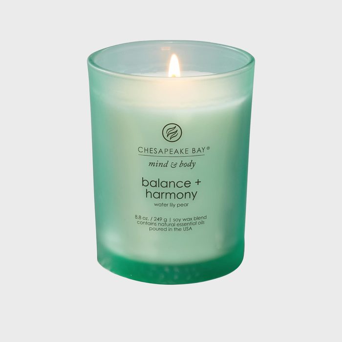 A lit green candle emits a warm glow, labeled 