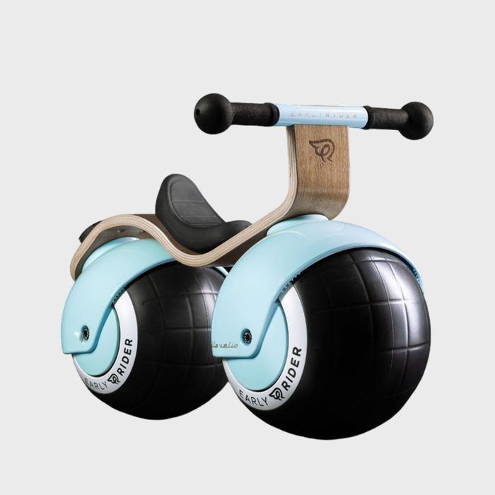 A balance bike rests, designed with large spherical wheels, light blue and black color scheme, minimalistic style, on a plain white background.
