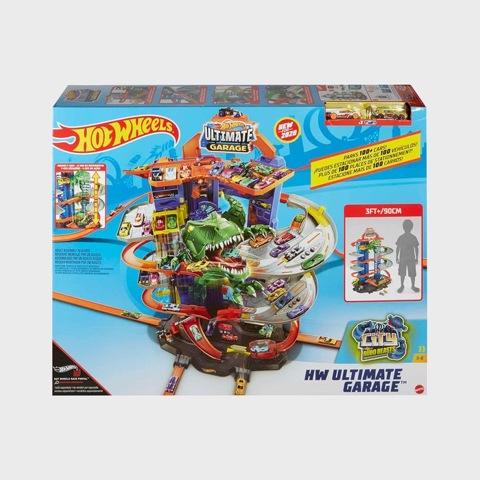 Hot Wheels set showcases cars racing on a colorful, multi-level track with a dinosaur feature, in a package displaying 