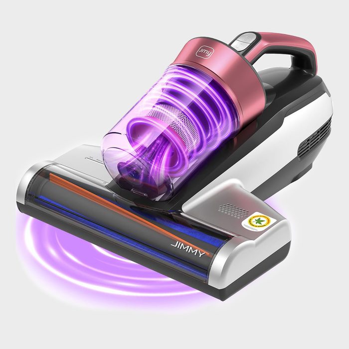 Vacuum cleaner emits purple light, showcasing powerful suction, on a plain white background. Text reads 