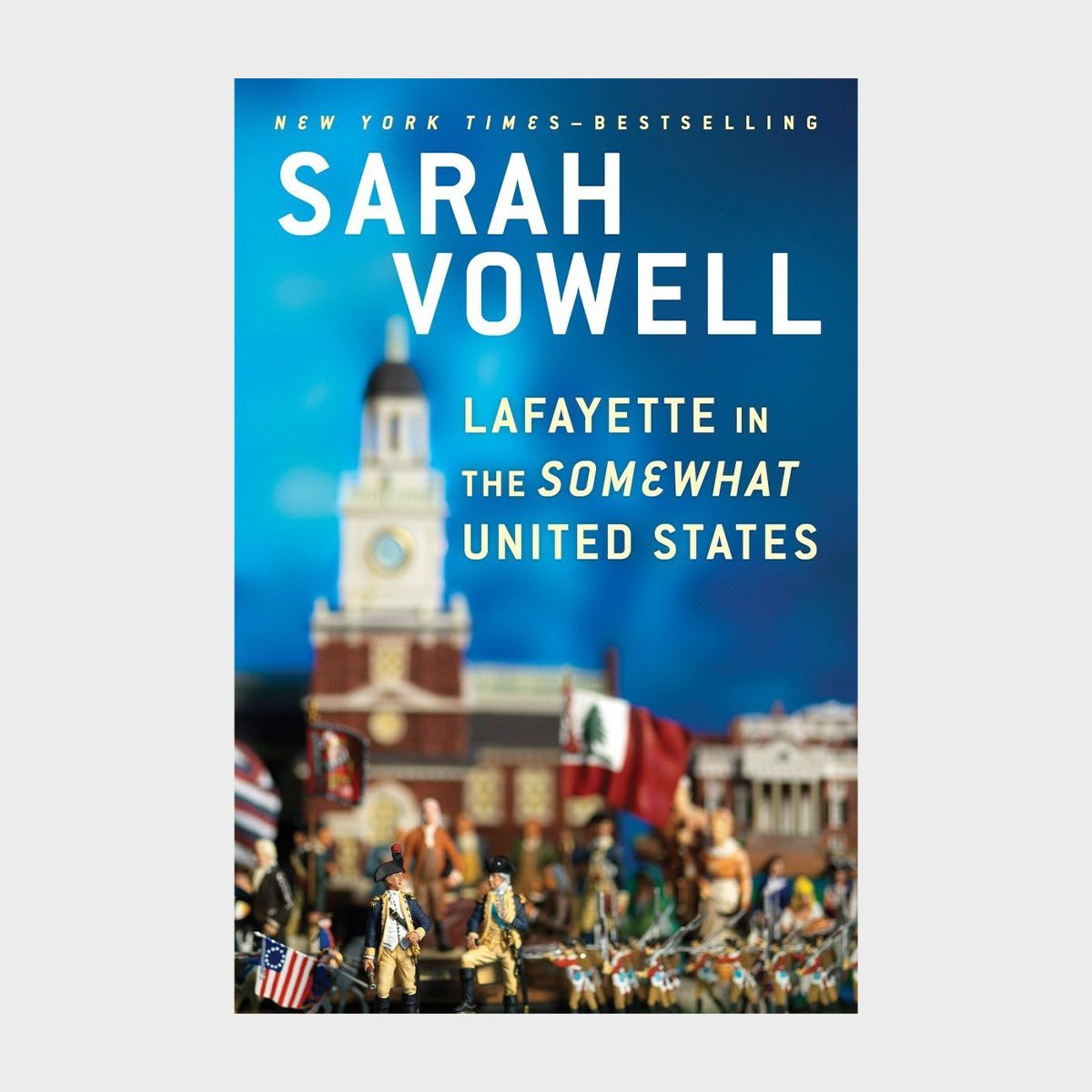 Soldiers stand before historic building, holding flags, set against clear blue sky. Text reads: "Sarah Vowell, Lafayette in the Somewhat United States."
