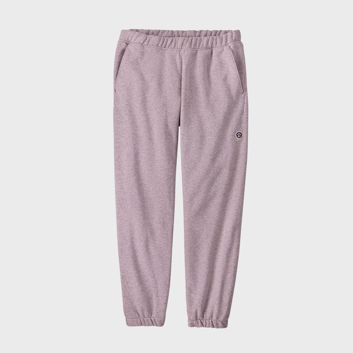 Gray sweatpants hang against a plain background, featuring an elastic waistband and cuffs, with two pockets and a small logo on one side.